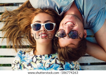 Similar – Two women with sunglasses smiling lying in blanket