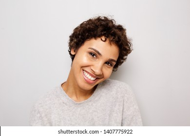 Close up portrait of happy young african american woman smiling white wall