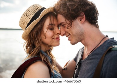Close up portrait of happy young couple in love embracing each other on beach