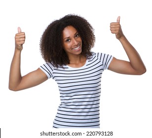 Close up portrait of a happy young woman smiling with thumbs up 