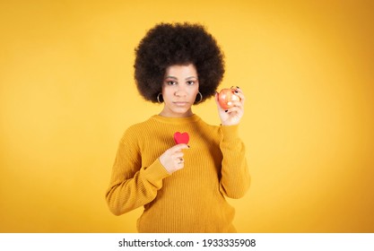 Close Up Portrait Of Healthy Young Black Woman Eating Apple Outdoors