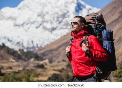 close up portrait of hiker looking at the horizon in the mountains on sunny day 