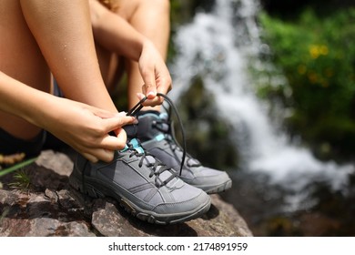 Close up portrait of a hiker tying shoe laces in the mountain - Shutterstock ID 2174891959