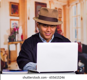 Close Up Portrait Of Indigenous Young Latin Man Using Laptop