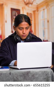 Close Up Portrait Of Indigenous Young Latin Man Using Laptop