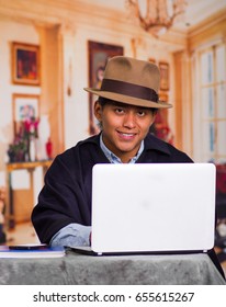 Close Up Portrait Of Indigenous Young Latin Man Using Laptop