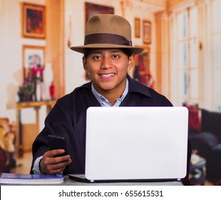 Close Up Portrait Of Indigenous Young Latin Man Using Laptop