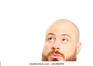 Close Up Portrait Of Interested Young Bearded Man Looking Up Isolated On White Background