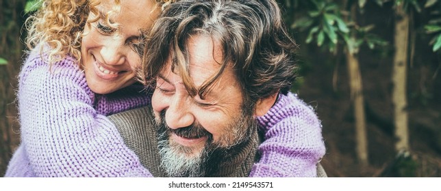 Close Up Portrait Of Joyful Caucasian Couple Hugging An Dloving With Forest Nature In Background. Man And Woman Smiling And Having Fun Together In Outdoor Leisure Activity. Banner Header Image