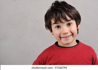 Close Up Portrait Of A Kid Smiling To The Camera