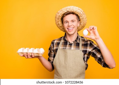 Close up portrait of kind emotion expressing cheerful excited joyful rejoicing farmer holding half-carton with eggs and demonstrating one fresh tasty delicious egg in hand isolated bright background - Powered by Shutterstock