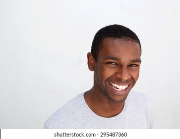 Close Up Portrait Of A Laughing Black Guy Posing Against White Background