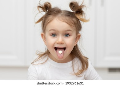 Close Up Portrait Of Little Funny Adorible Funny Child Girl With Pill On Her Tongue At Home ,taking Medicine, Taking Vitamins,tongue, Eating, Medical, Nutrition, Healthcare Concept