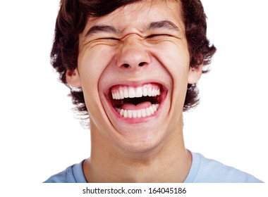 Close up portrait of loudly laughing young man isolated on white background