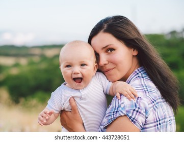 Close up portrait of a loving mother holding baby