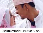 close up portrait of a malay bride and groom under veil with lovely emotion. Concept of malay wedding and marriage