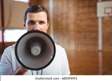 Close up portrait of male coach using megaphone - Powered by Shutterstock