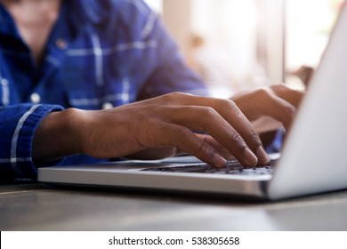 Close up portrait of male hands typing on laptop computer 