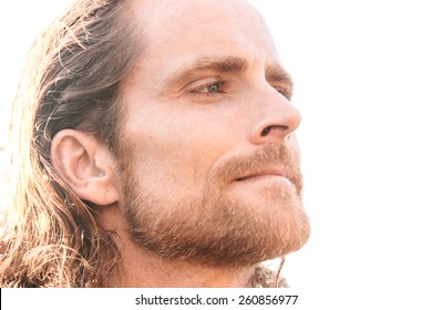 Close Up Portrait Of A Man With Beard And Long Hair Looking Far Away