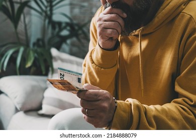 Close Up Portrait Of Man Holding Cash Money Banknotes With Worried Expression And Bad Emotion. Economy Problems Family Concept. Husband Stressed And Frustrated For Bankrupt Crisis At Home.