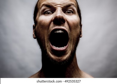 Close Up Portrait Of A Man Shouting, Mouth Wide Open