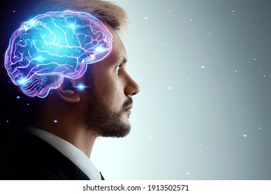 Close up portrait of a man from the side in profile and a hologram of a working brain. The concept of intelligence, brain work, thought process