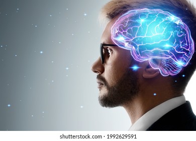 Close up portrait of a man from the side in profile and a hologram of a working brain. The concept of intelligence, brain work, thought process