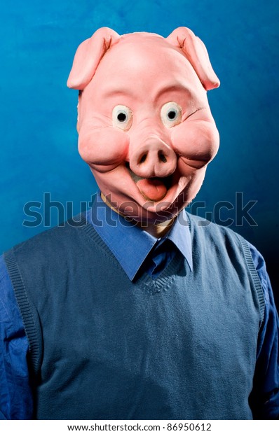 Close up portrait of a man wearing a pig mask.\
Both funny and spooky.