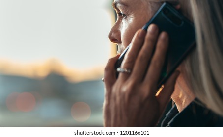 Close Up Portrait Of Mature Business Woman Talking Over Cell Phone. Side View Of Senior Business Woman Making A Phone Call.