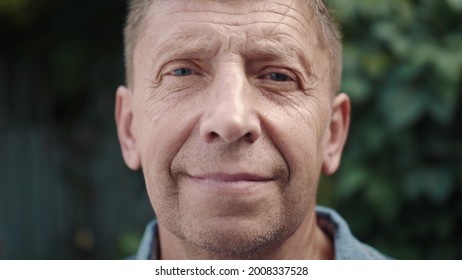 Close Up Portrait Of Mature Businessman Smiling Confident Enjoying Success. Face Of Attractive Senior Man Close Up. Elderly Male Looking At The Camera And Smiling.