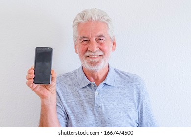 Close Up And Portrait Of Mature Man Holding A Phone And Showing At The Camera It - Online And Social Network Senior Lifestyle And Concept