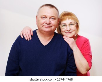 Close Up Portrait Of Middle Aged Couple Over White Background