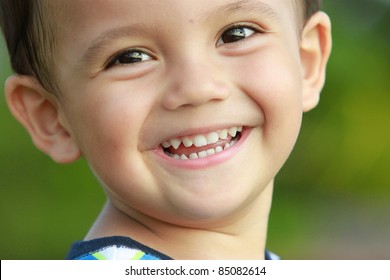 Close Up Portrait Of Mixed Race Kid Smiling To The Camera