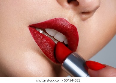 Close Up Portrait Model Applying Dark Red Lipstick.. Professional Fashion Retro Make-up.