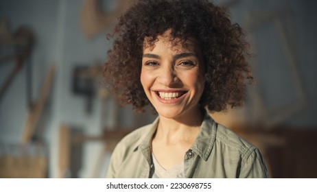 Close Up Portrait of a Multiethnic Brunette with Curly Hair and Brown Eyes. Happy Creative Young Woman Charmingly Smiling and Feeling Joyful. Thinking Up Ideas About Greater Future. - Powered by Shutterstock