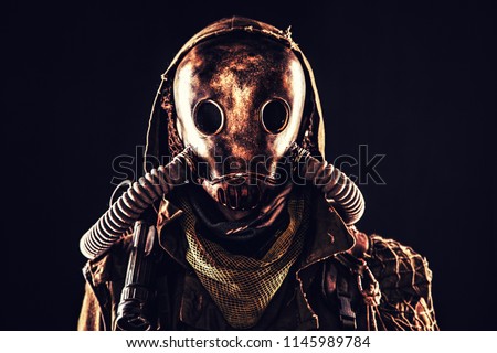 Close up portrait of nuclear post-apocalypse survivor, living underground mutant or creature, skilled stalker wearing rags and armored full-face gas mask or air breathing apparatus, toned shoot