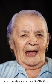 Close Up Portrait Of Old Grandma On Black Background