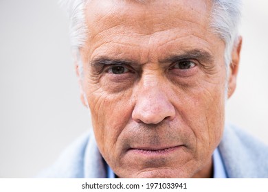 Close up portrait older man head with eyes staring  - Shutterstock ID 1971033941