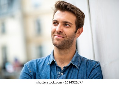 Close Up Portrait Older Man Leaning Against Wall And Looking Away