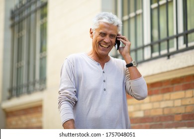 Close Up Portrait Older Man Talking With Mobil Phone And Laughing In City