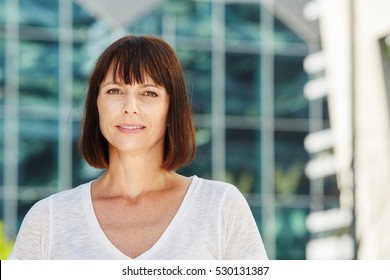 Close up portrait of older woman in city with neutral expression - Shutterstock ID 530131387