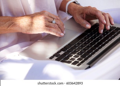 Close Up Portrait Of Older Woman Hands Typing On Laptop Computer