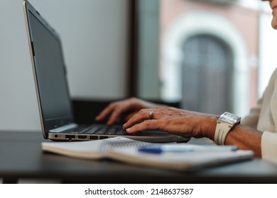 Close Up Portrait Of Older Woman Typing On Laptop Computer