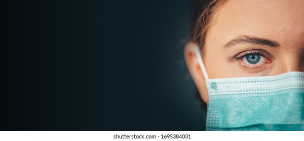 Close Up Portrait Photo, Eye Of Yong Female Doctor. Protection Against Contagious Disease, Black Background, Panorama Photo, Web Banner