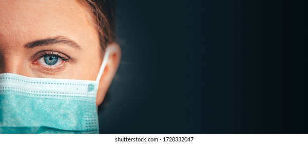 Close Up Portrait Photo, Eye Of Yong Female Doctor. Protection Against Contagious Disease, Coronavirus, Hygienic Face Surgical Medical Mask. Panorama Photo, Black Edit Space