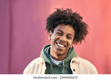 Close up portrait photo of young happy African American cool hipster teen guy face laughing on red city wall lit with sunlight. Smiling cool rebel gen z teenager model standing outdoors. Headshot. - Powered by Shutterstock