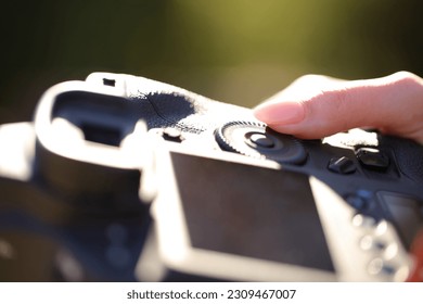 Close up portrait of a photographer finger setting diaphragm aperture on camera dial