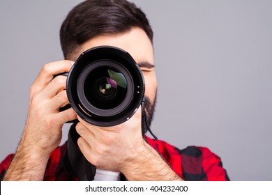 Close Up Portrait Of Photographer Taking Pictures With Digital Camera