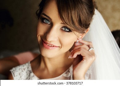 Close up portrait of pretty bride in hotel room