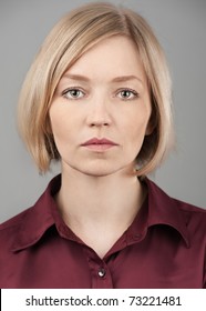 Close Up Portrait Of A Pretty Young Blond Woman With Serious Face